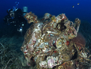 A diver inspects the remains of one of the Wellington bomber's Hercules engines.